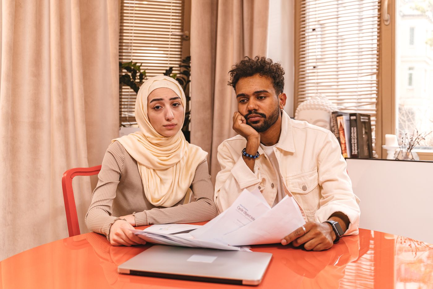 Two buyers reading through papers together at home