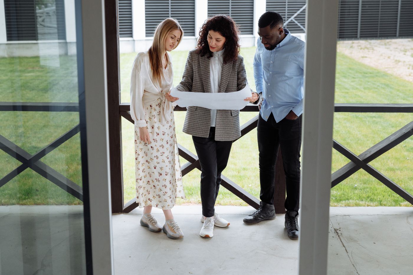 A sales consultant going through a plan with two buyers
