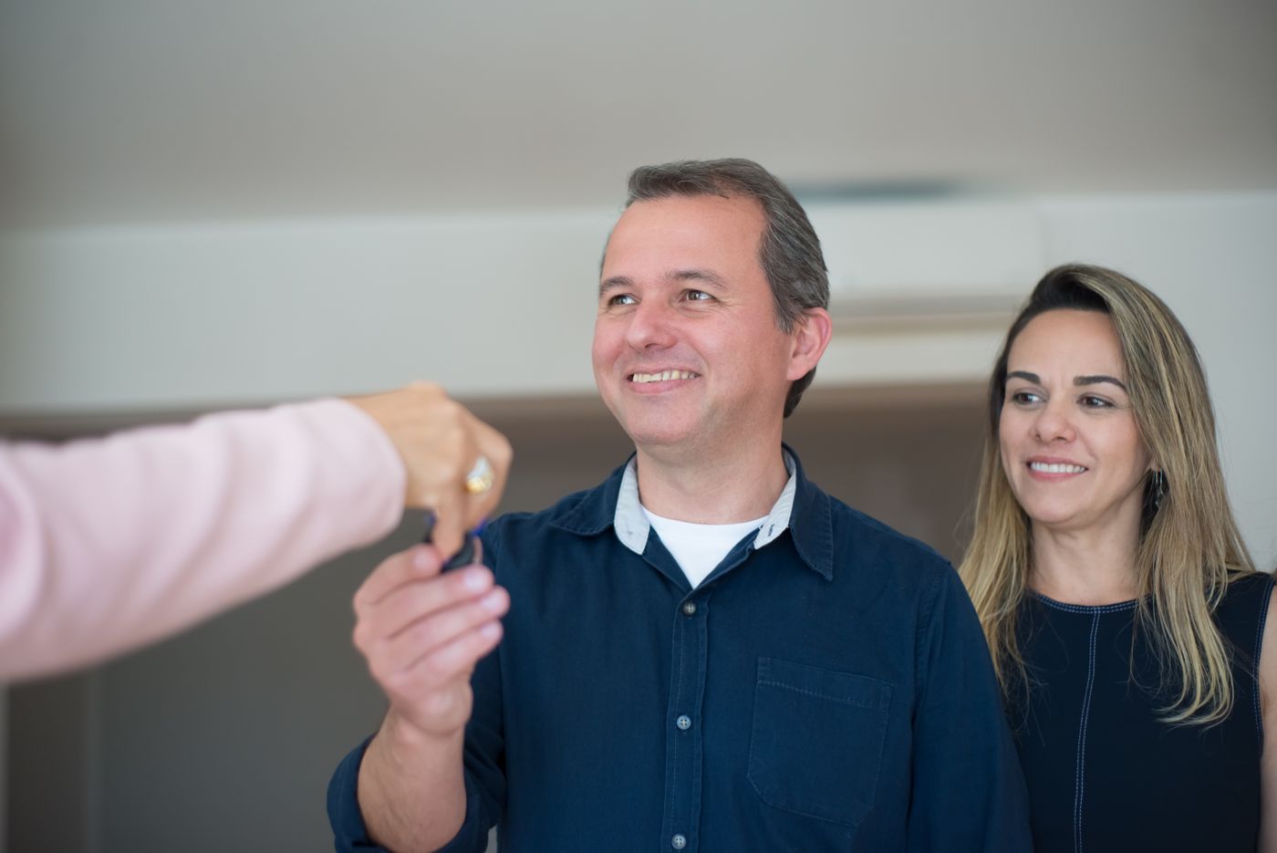 Two buyers receiving the keys to a new home