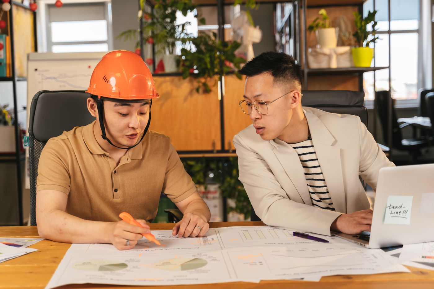A project manager going through plans with a colleague