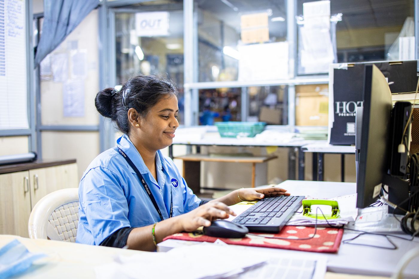 A sales administrator working at a desk computer