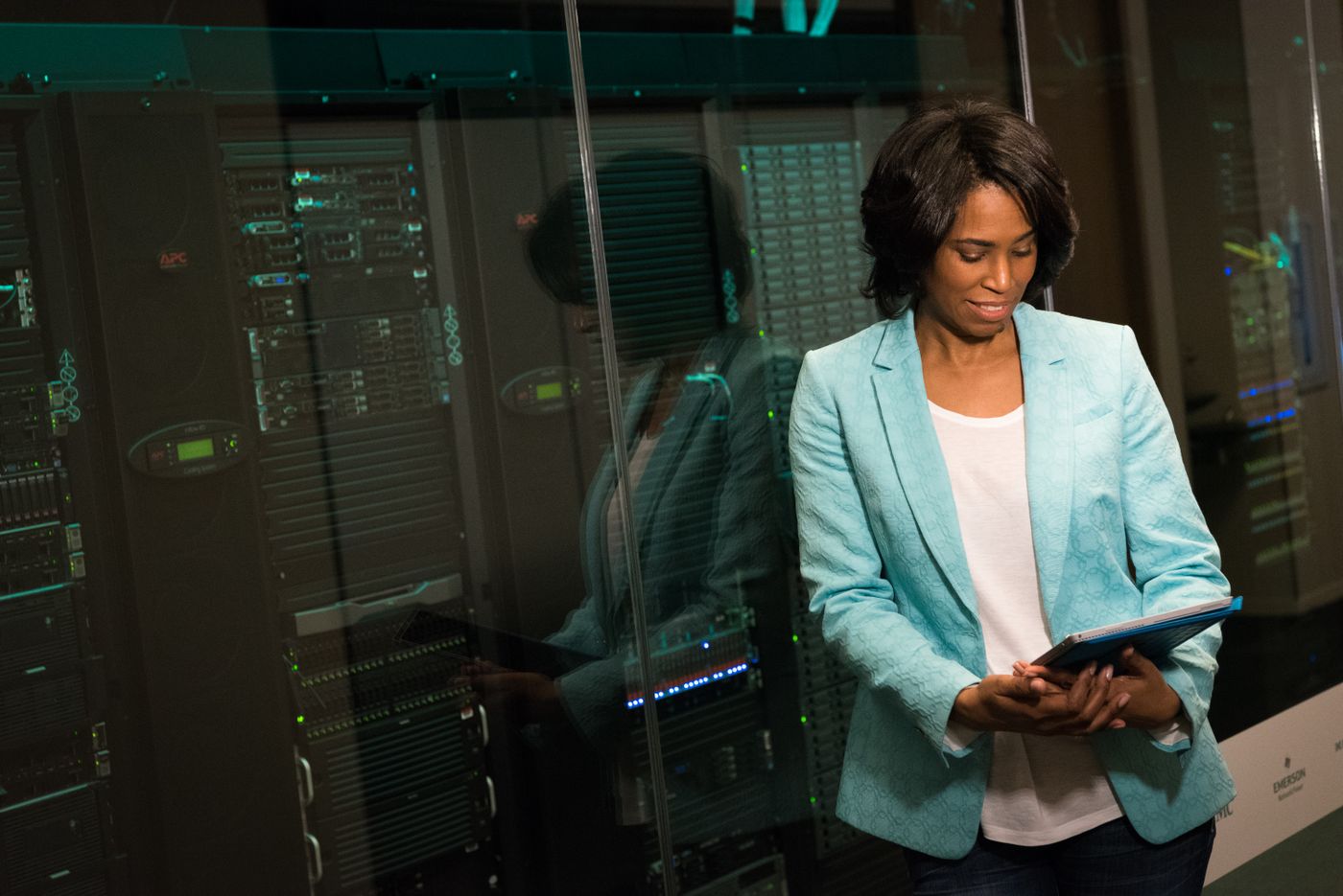 An IT engineer with a tablet in a server room